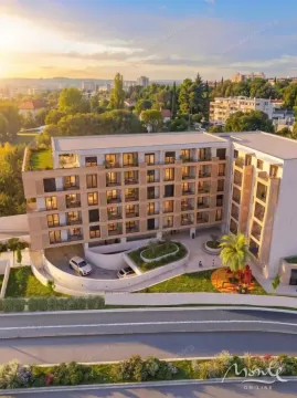 Pogled iz vazduha na spoljašnjost moderne stambene zgrade sa uređenim dvorištem i igralištem. - image 17