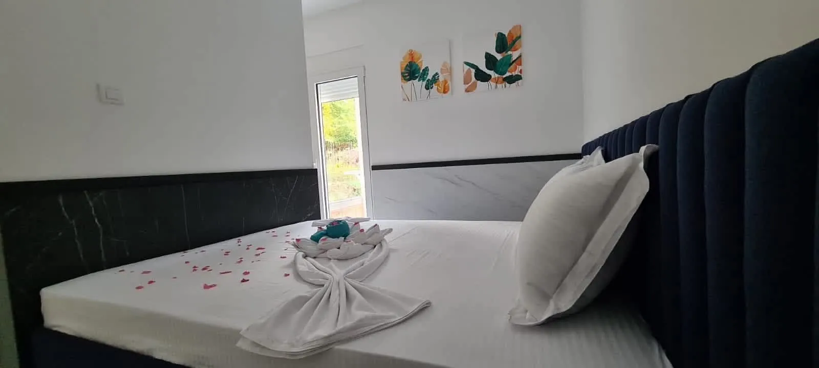 Tidy bedroom with a double bed and bed decoration.