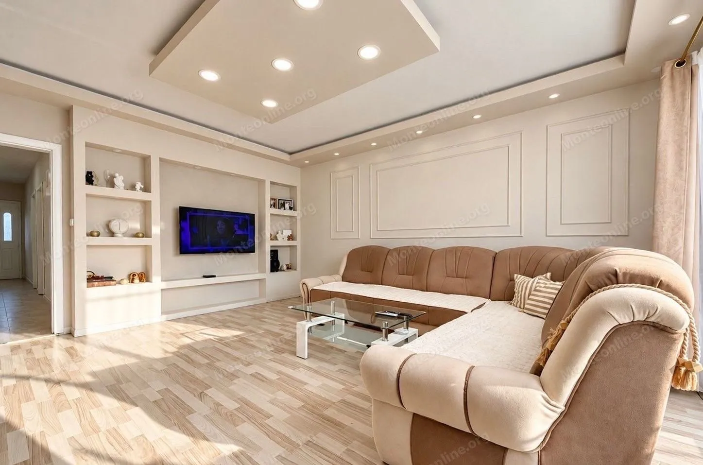 Spacious living room with a sectional sofa and recessed lighting.