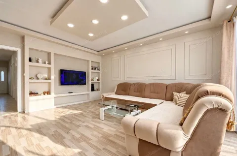 Spacious living room with a sectional sofa and recessed lighting. - image 16