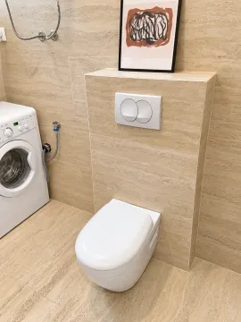 Modernly equipped bathroom with a built-in toilet and washing machine. - image 11