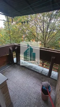 Covered balcony with a view of green trees. - image 7