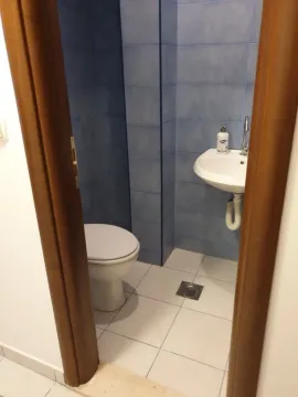 Small bathroom with blue tiles and sanitary ware. - image 2