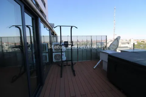 Spacious terrace with wooden flooring, workout equipment, and city views. - image 20