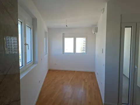 Empty bright room with parquet flooring and an air conditioner. - image 8