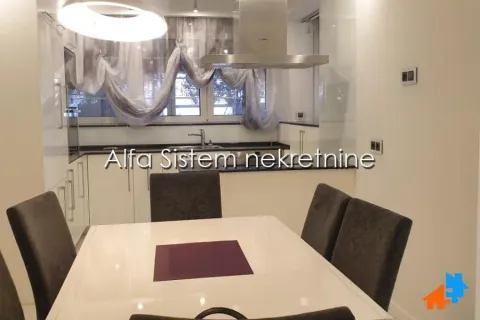 Modern kitchen with a dining table and chairs. - image 3