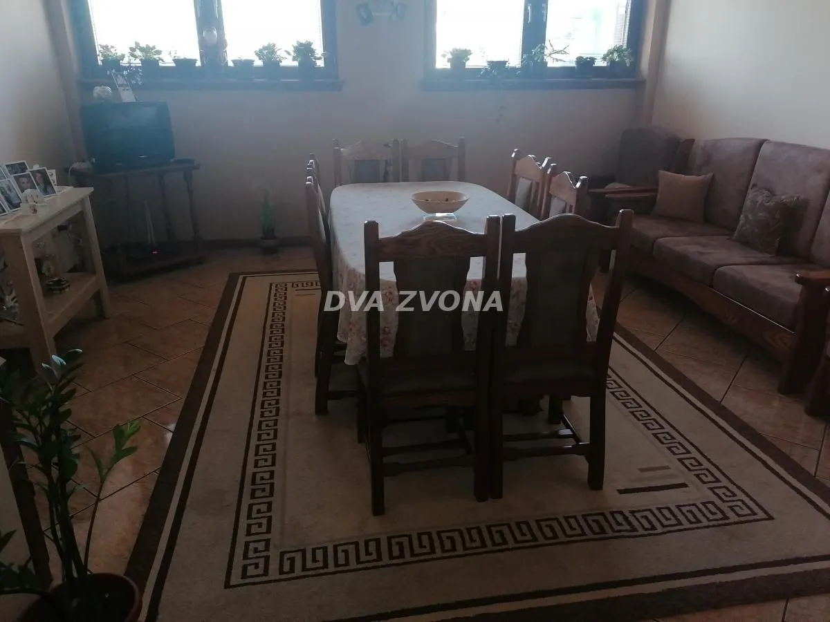 Living room with a sofa set and a dining table.