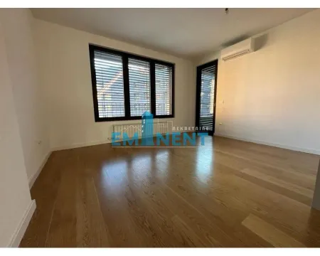 Empty room with wooden flooring, large windows, and an air conditioning unit. - image 6