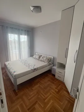 Namještena spavaća soba sa bračnim krevetom, garderoberom i parketom na podu. - image 4