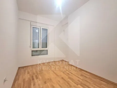 Empty room with parquet flooring and a window. - image 17