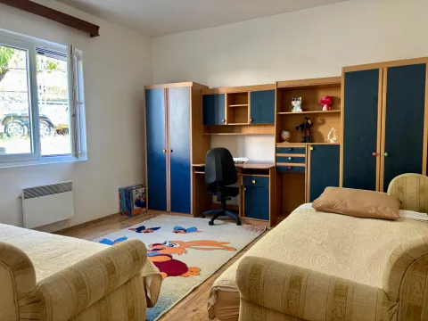 Children's bedroom with two beds, a desk, and a wardrobe. - image 7