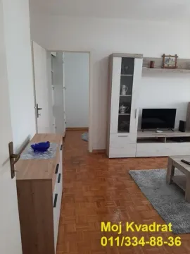 Living room with furniture, television, and a view of the hallway. - image 3