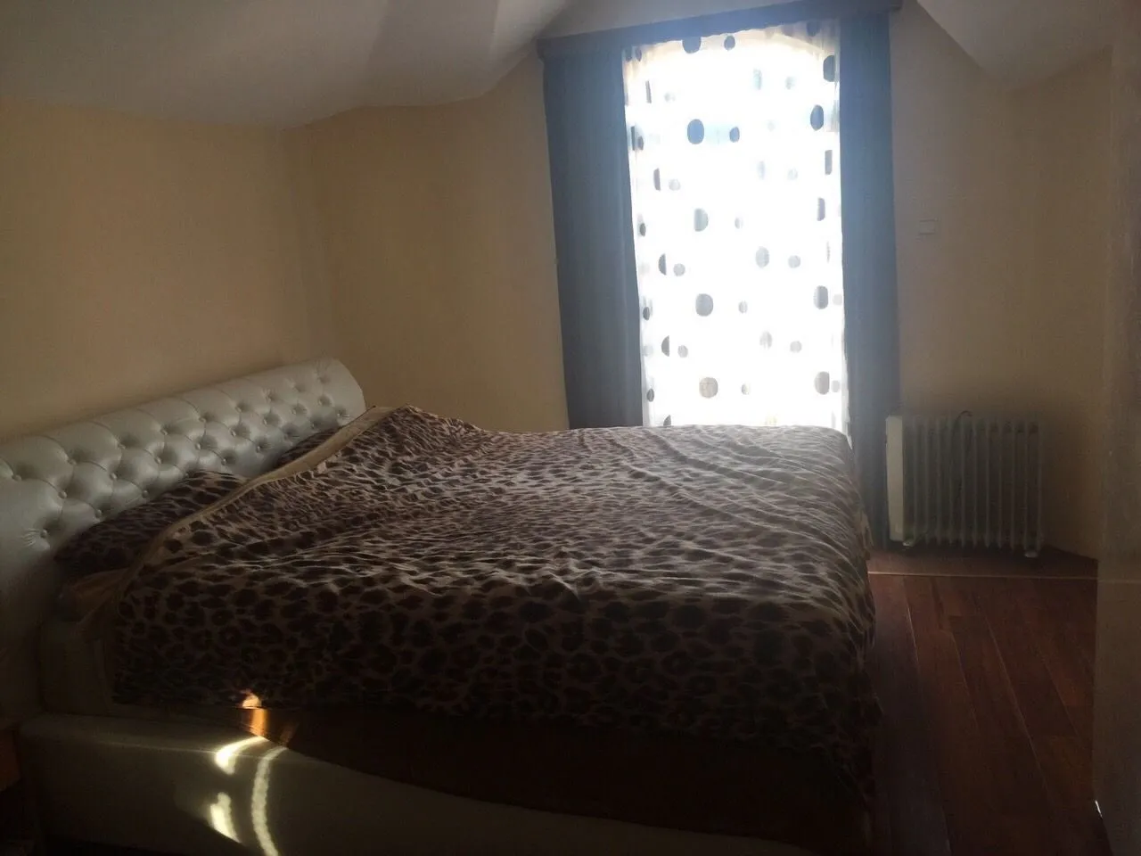 Simple bedroom with a double bed and a window.