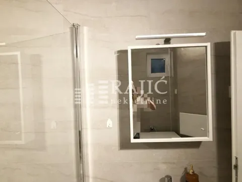 Modernly equipped bathroom with a shower cabin and a mirror. - image 8