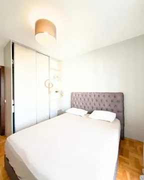 Bedroom with a double bed and a built-in wardrobe. - image 2