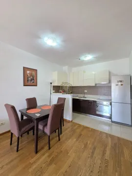 Kitchen with dining area featuring a wooden table and chairs. - image 6