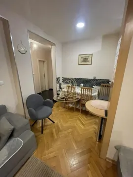 Living room with a dining table and parquet flooring. - image 6