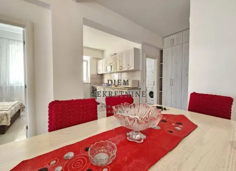 Dining area with a table and chairs and a view of the kitchen. - image 8