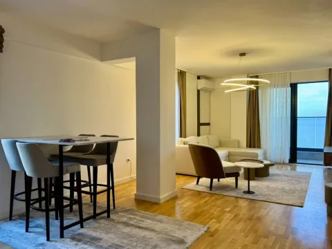 Modern living room with a dining table and access to a terrace with a sea view. - image 11
