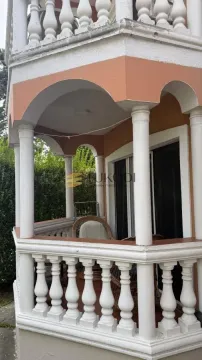 Covered terrace with columns and a white stone balustrade. - image 17