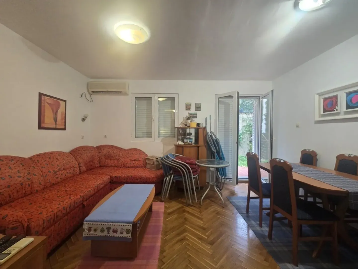 Living room with a sofa set and a dining area.