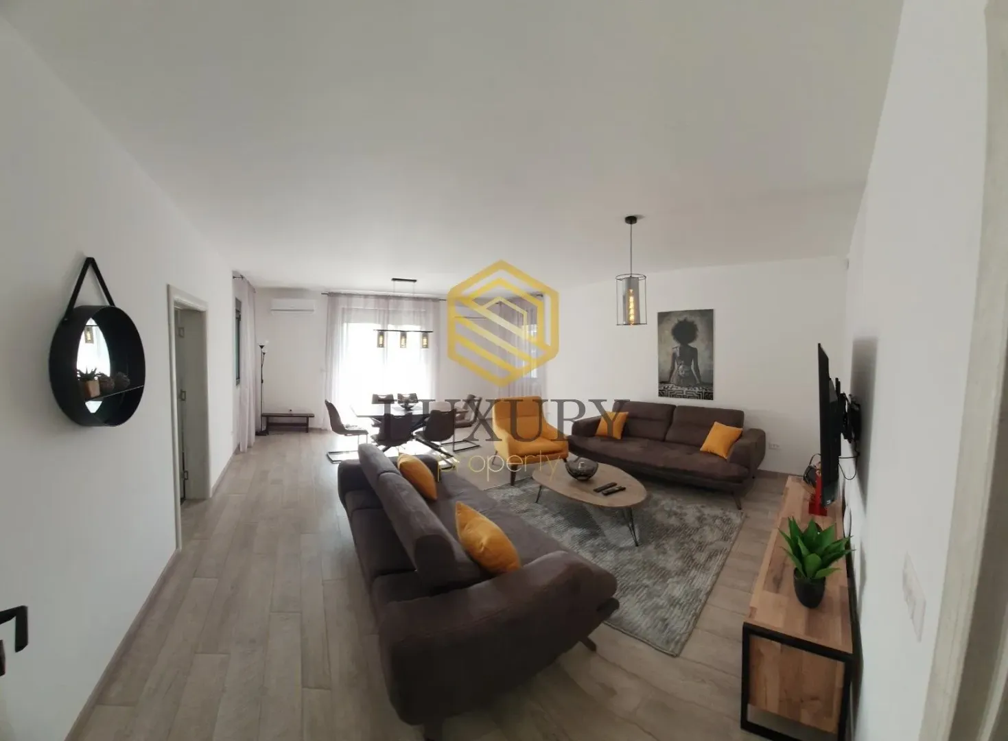 Spacious and bright living room with a sofa set and dining area.
