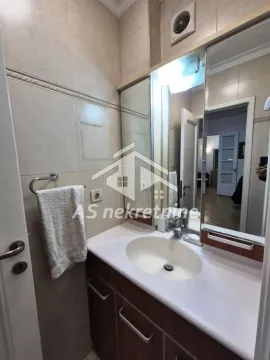 Bathroom with a vanity sink, cabinet, and large mirror. - image 18