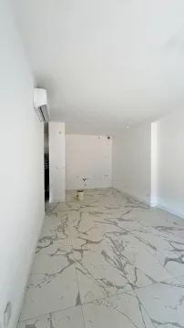 Empty room with marble tile flooring and an air conditioning unit on the wall. - image 15