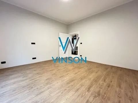 Empty room with laminate flooring and white walls. - image 5