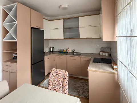 Small kitchen with fitted units and a black refrigerator. - image 6