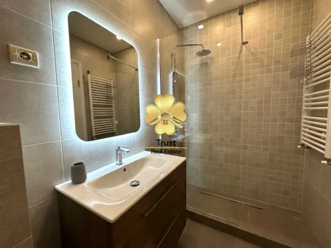 Modernly equipped bathroom with a walk-in shower and vanity unit. - image 9