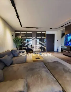Modern living room with a large corner sofa and a TV. - image 8