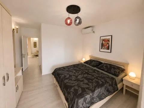 Modern bedroom with a double bed, nightstands, and a wardrobe. - image 8