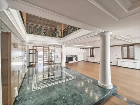 Spacious living room with a gallery, columns, and parquet flooring. - image 2