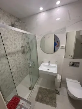 Modern equipped bathroom with a shower cabin. - image 4