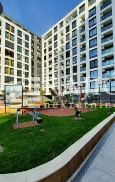 Courtyard with a playground in front of a modern apartment building. - image 17