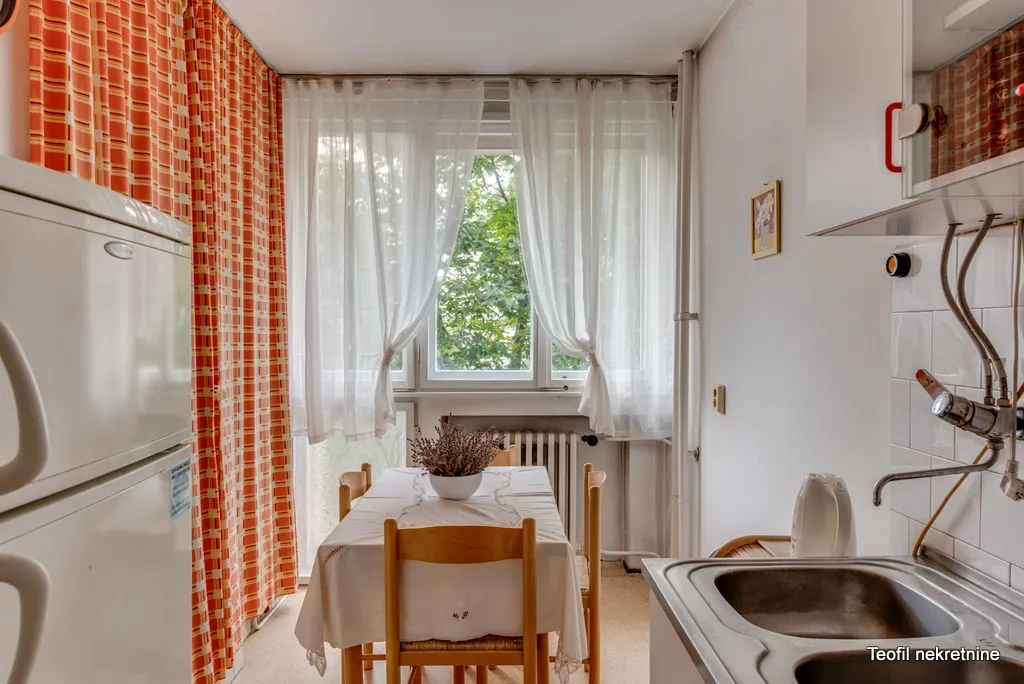 Smaller kitchen with a dining table and window.