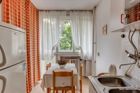 Smaller kitchen with a dining table and window. - image 14