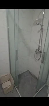 Modern walk-in shower with marble-look tiles in a bathroom. - image 6