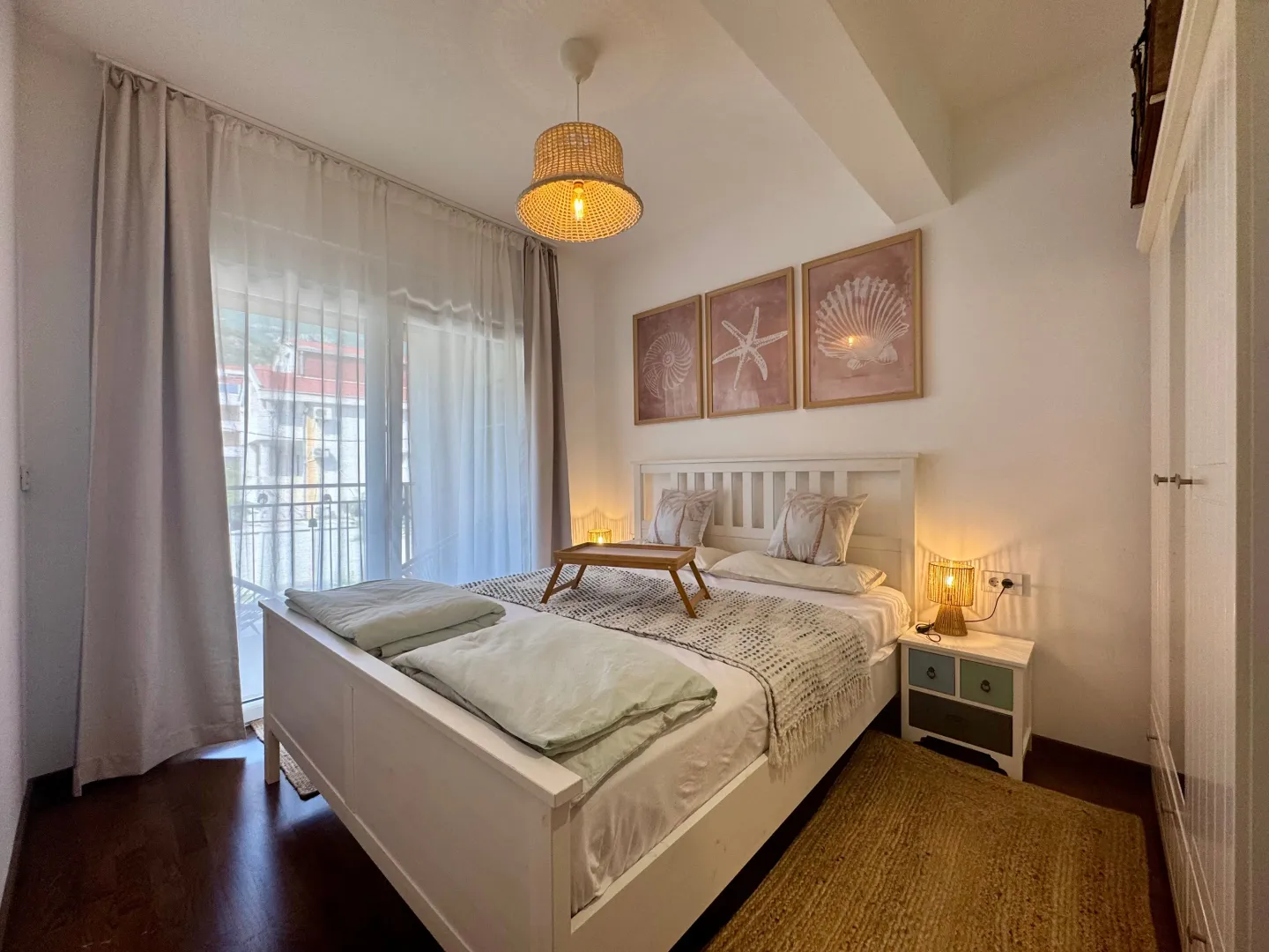 Bright and tidy bedroom with a double bed and balcony access.