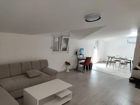 Bright living room featuring a sofa, coffee table, and dining area. - image 3