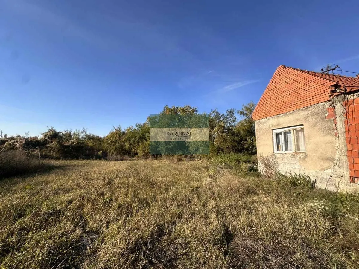 Pogled na dvorište i spoljašnjost kuće sa travnjakom.