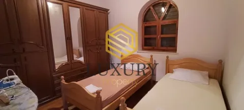 Bedroom with two wooden beds and a large wardrobe. - image 14