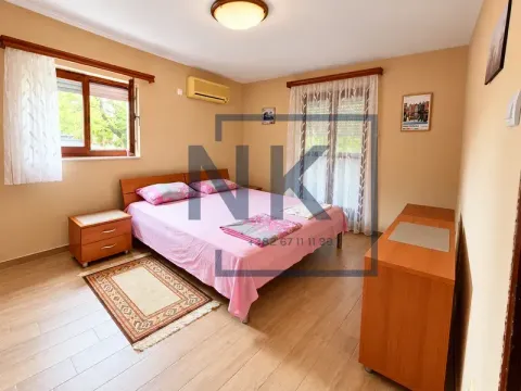Furnished bedroom with a double bed, bedside tables, and a wooden chest of drawers. - image 15