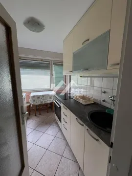 Smaller kitchen with a dining table by the window. - image 3