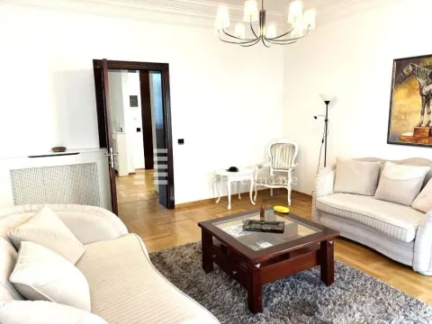 Spacious living room with a sofa and a wooden coffee table. - image 2