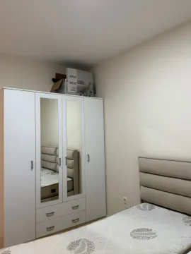Furnished bedroom with a wardrobe and bed. - image 8