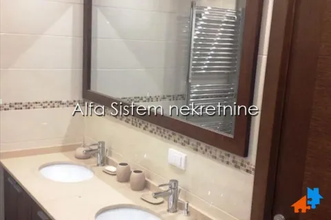 Bathroom with double sink and large mirror. - image 18