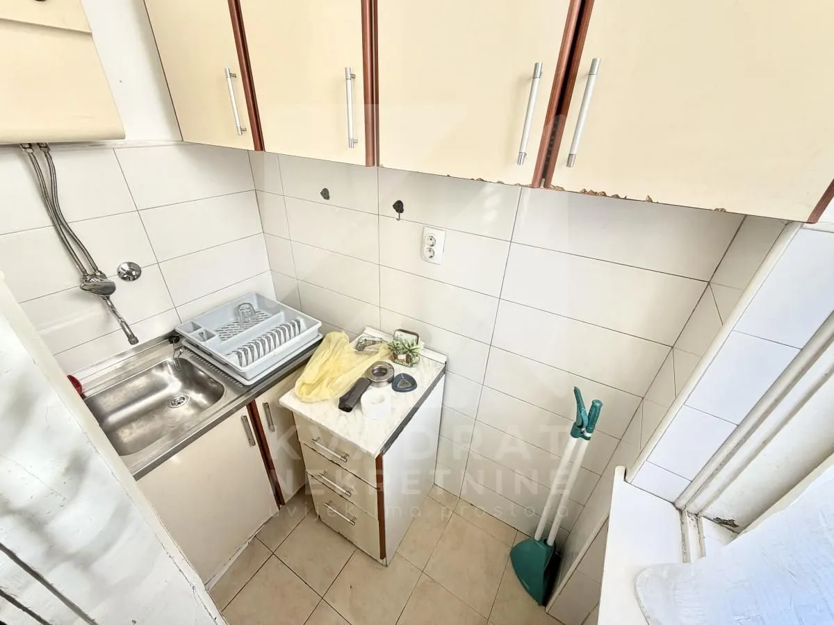 Smaller kitchen with a sink and wall cabinets.