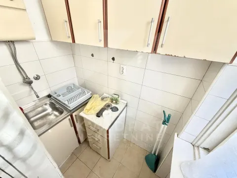 Smaller kitchen with a sink and wall cabinets. - image 12